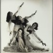 Four ballet dancers posing with their arms out and leaning in various directions
